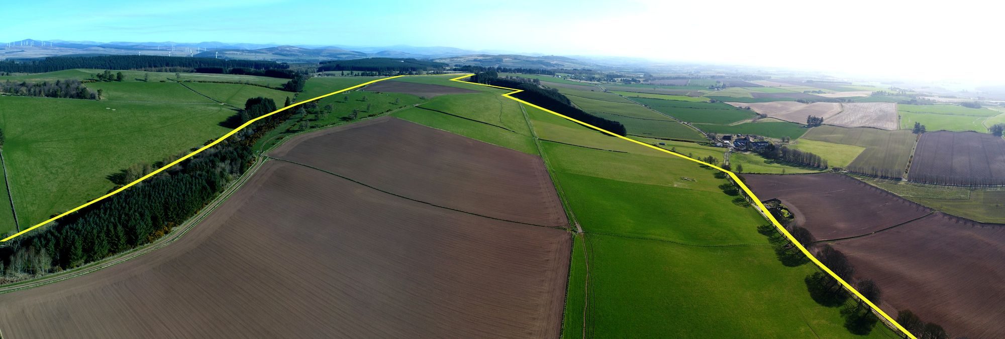 Aerial panorama of farmland with the estate boundary drawn as a yellow line