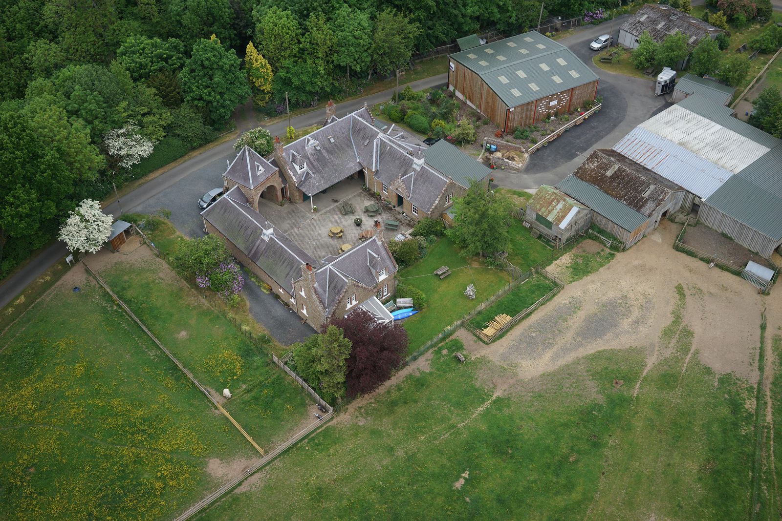Aerial view of a farm steading with each building outlined and coloured by roof condition, and the fields marked