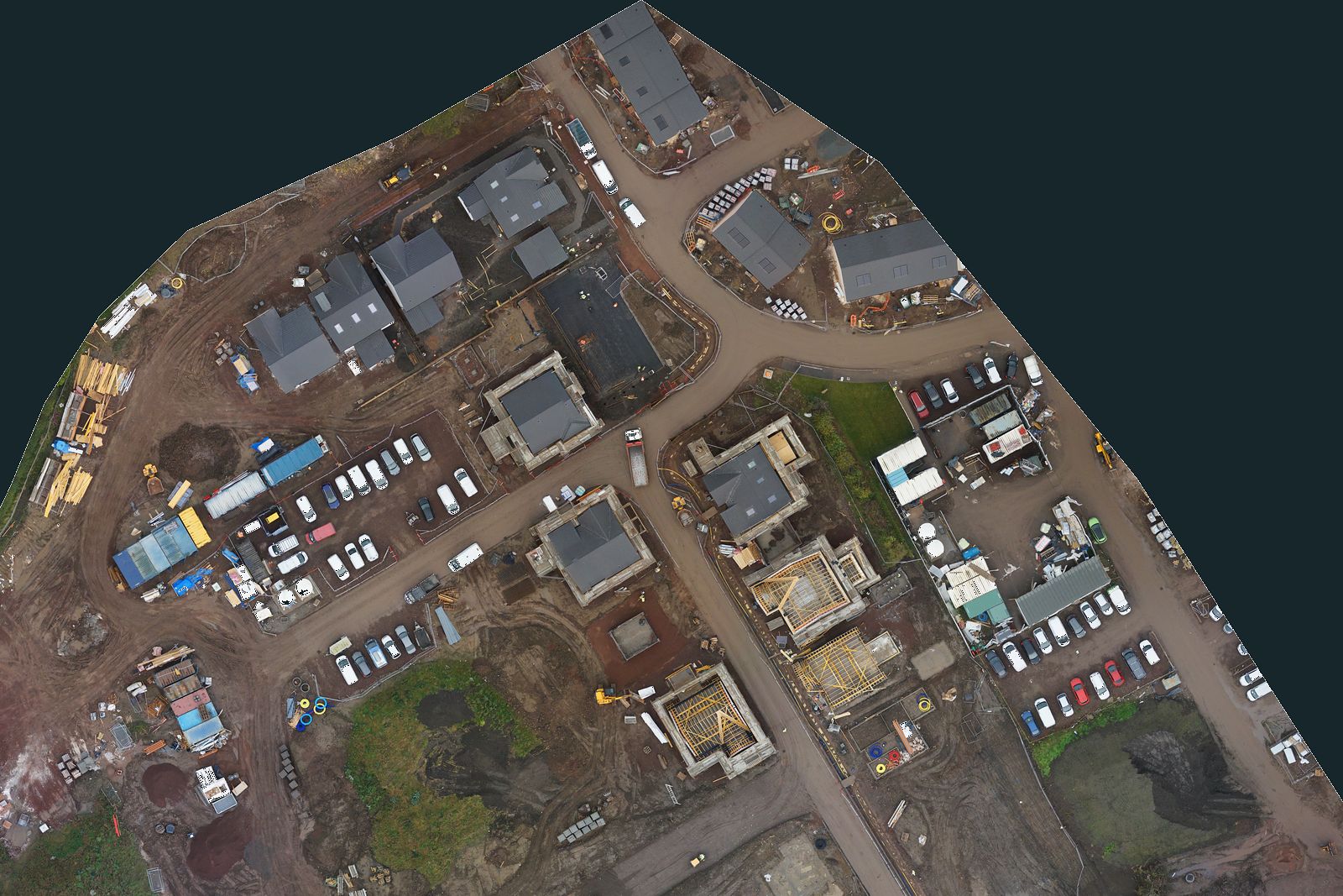 Straight-down drone map of a housing site with every plot coloured by build stage, the site compound and haul road marked