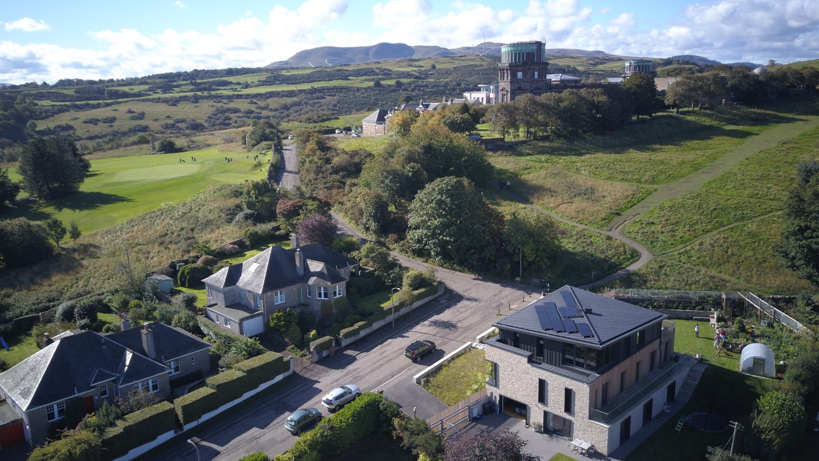 Modern three-storey house on Blackford Hill with the Royal Observatory and the Pentland Hills behind
