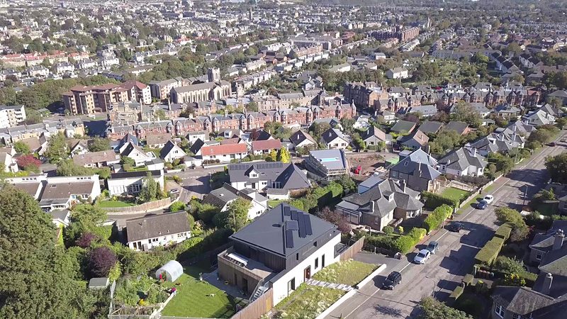 Aerial view over south Edinburgh rooftops towards Arthur's Seat, with the new house in the foreground